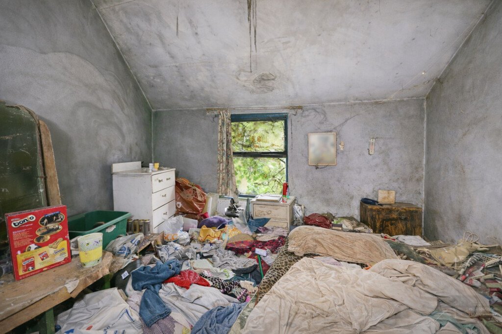A rubbish-filled three-bed house with collapsed ceilings and unsafe floors has hit the market for £125,000, but buyers must bid blind as council rules ban entry