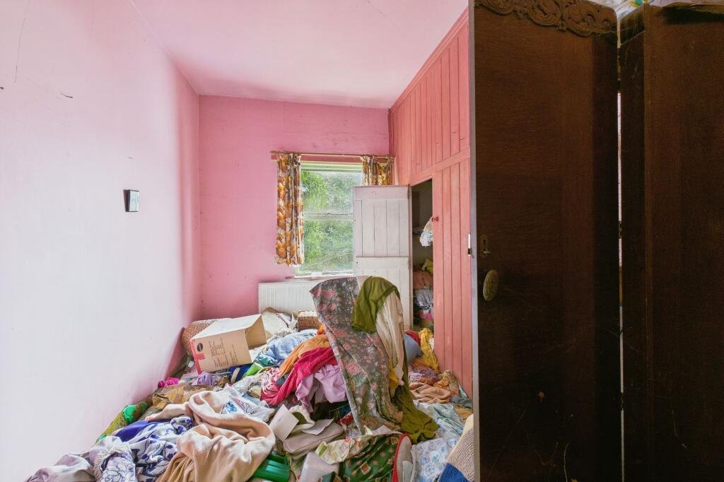 A rubbish-filled three-bed house with collapsed ceilings and unsafe floors has hit the market for £125,000, but buyers must bid blind as council rules ban entry