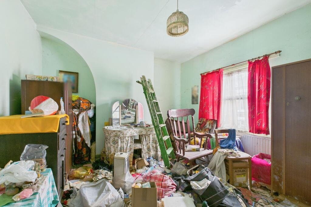 A rubbish-filled three-bed house with collapsed ceilings and unsafe floors has hit the market for £125,000, but buyers must bid blind as council rules ban entry