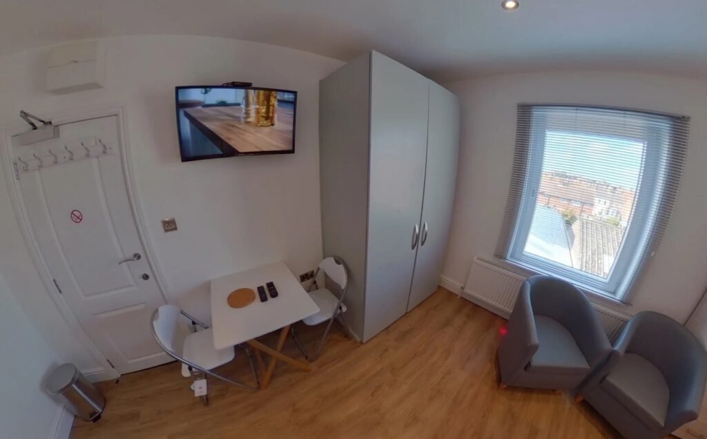 A £920 a month studio flat sparks shock after revealing a full kitchen hidden inside a cupboard at the foot of the bed, cramming living, dining and cooking into one tiny space.