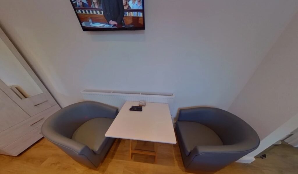 A £920 a month studio flat sparks shock after revealing a full kitchen hidden inside a cupboard at the foot of the bed, cramming living, dining and cooking into one tiny space.