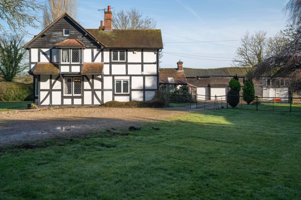 Pink Floyd guitarist David Gilmour former Essex home set in 4.66 acres with a lake and studio outbuilding is for sale at £1.1m offering buyers rock history.