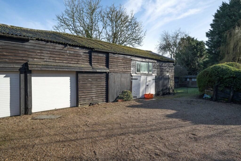 Pink Floyd guitarist David Gilmour former Essex home set in 4.66 acres with a lake and studio outbuilding is for sale at £1.1m offering buyers rock history.