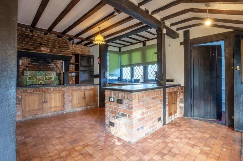 Pink Floyd guitarist David Gilmour former Essex home set in 4.66 acres with a lake and studio outbuilding is for sale at £1.1m offering buyers rock history.