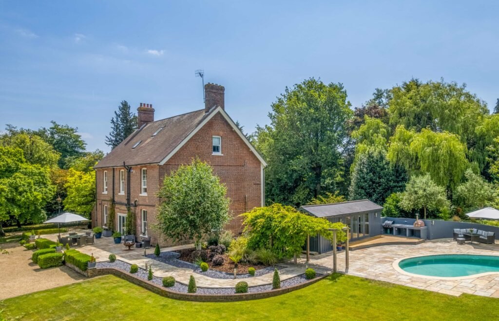 A Georgian country home once owned by James Bond’s gadget master Q hits the market, blending historic charm with modern upgrades and strong eco credentials in a sought-after setting