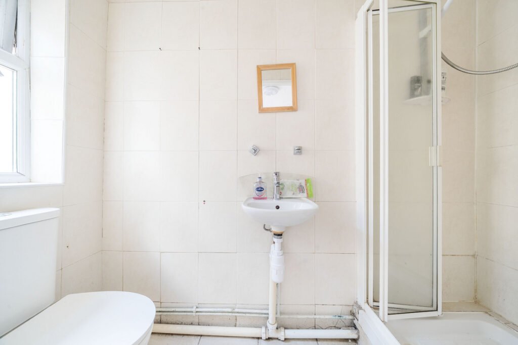 An eight-bedroom home next door to Fred West's infamous Gloucester murder house is on the market, with agents warning buyers of the street's dark and notorious history.