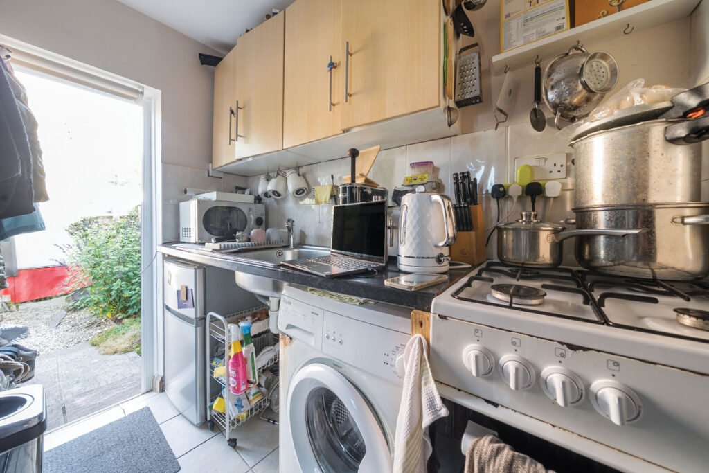 An eight-bedroom home next door to Fred West's infamous Gloucester murder house is on the market, with agents warning buyers of the street's dark and notorious history.