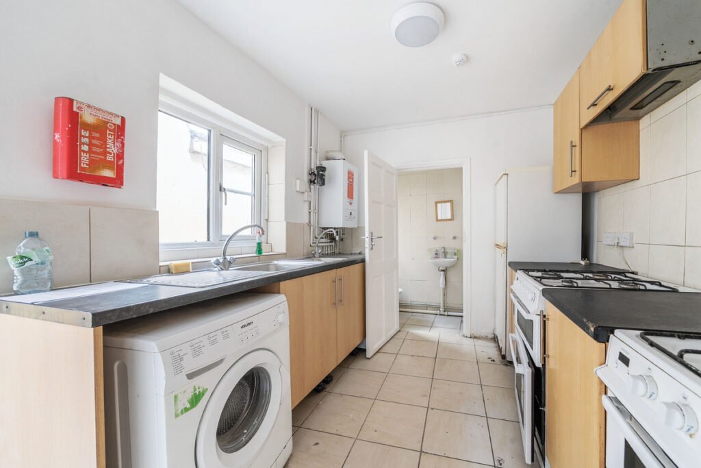 An eight-bedroom home next door to Fred West's infamous Gloucester murder house is on the market, with agents warning buyers of the street's dark and notorious history.