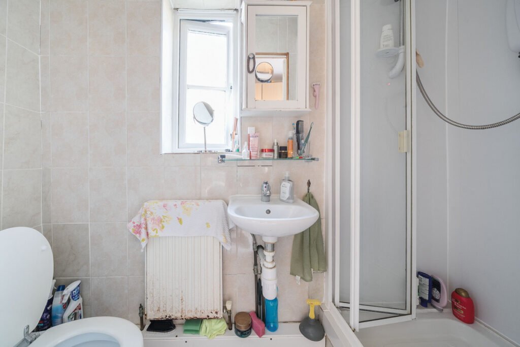 An eight-bedroom home next door to Fred West's infamous Gloucester murder house is on the market, with agents warning buyers of the street's dark and notorious history.