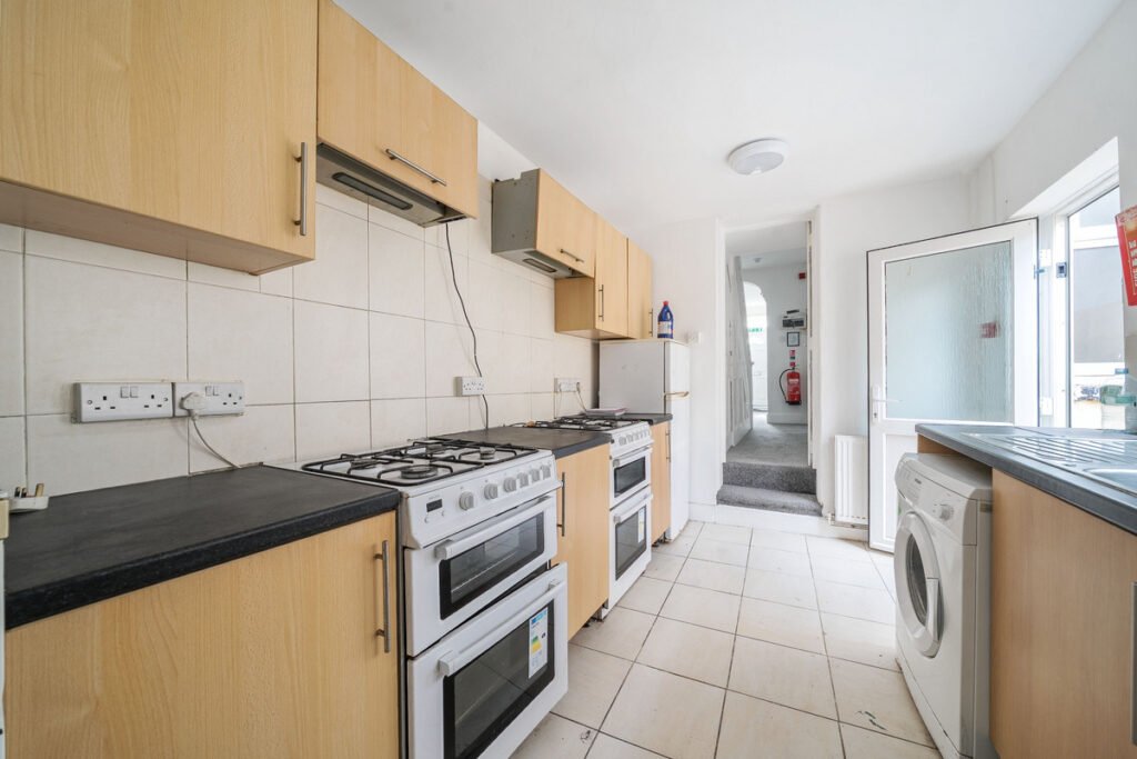 An eight-bedroom home next door to Fred West's infamous Gloucester murder house is on the market, with agents warning buyers of the street's dark and notorious history.