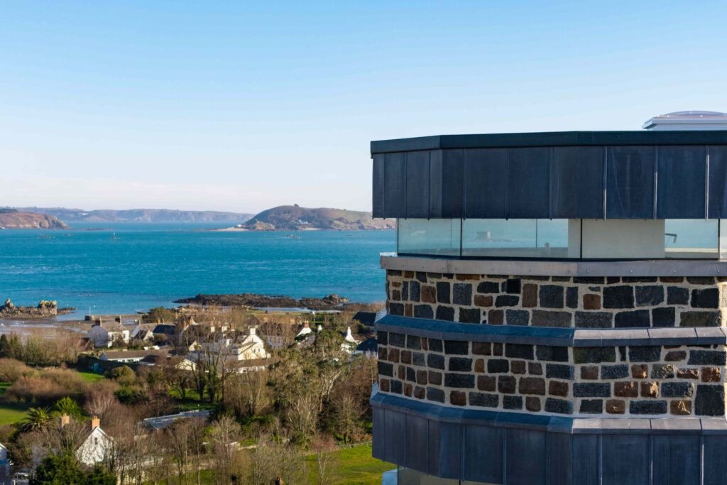 A historic 69ft windmill in Guernsey, once a WWII lookout, is for sale with plans to convert it into a striking four-bedroom home with observation deck and quarry views.