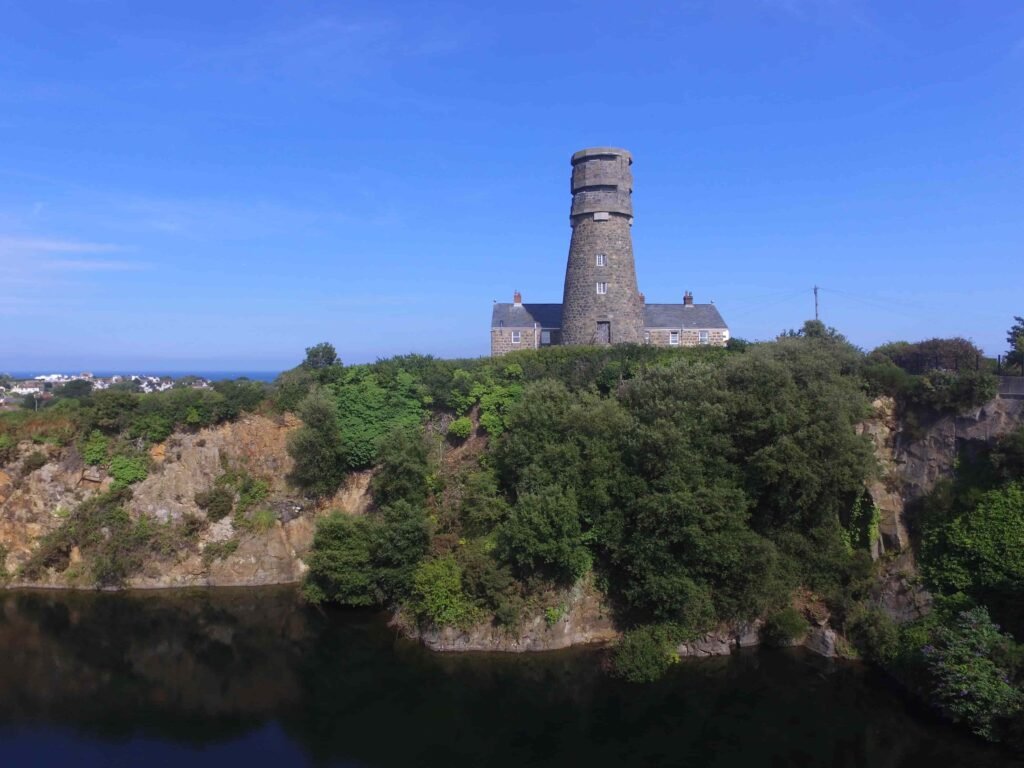 A historic 69ft windmill in Guernsey, once a WWII lookout, is for sale with plans to convert it into a striking four-bedroom home with observation deck and quarry views.