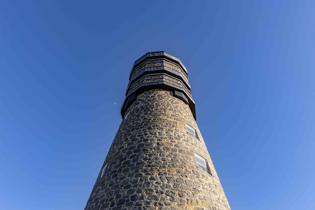 A historic 69ft windmill in Guernsey, once a WWII lookout, is for sale with plans to convert it into a striking four-bedroom home with observation deck and quarry views.