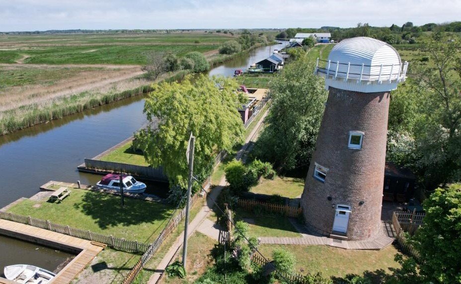A historic converted windmill in the Norfolk Broads has hit the market for £495,000, offering river views, original features and a rare private mooring in a tranquil setting.