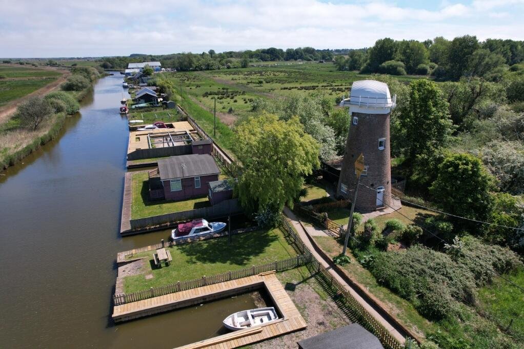 A historic converted windmill in the Norfolk Broads has hit the market for £495,000, offering river views, original features and a rare private mooring in a tranquil setting.