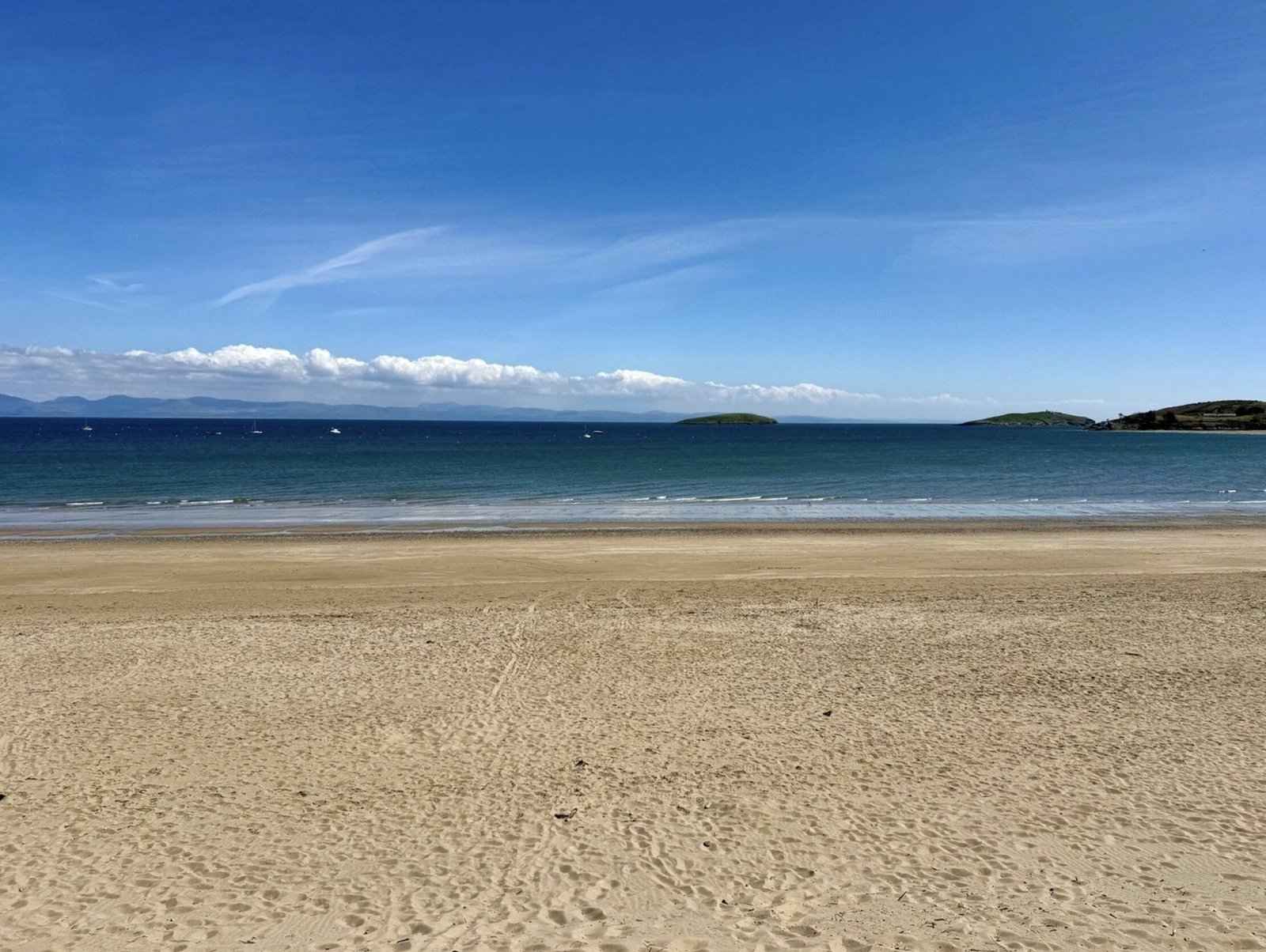 A small beach hut without mains power on sale for £200,000 at Abersoch beach, Gwynedd, Wales - same price as nearby houses with stunning Cardigan Bay views.