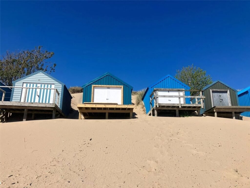 A small beach hut without mains power on sale for £200,000 at Abersoch beach, Gwynedd, Wales - same price as nearby houses with stunning Cardigan Bay views.