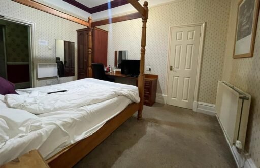 A dilapidated hotel bedroom with stained carpets and peeling wallpaper in Preston is on sale for £40,000, leaving bewildered Brits questioning what exactly they would be buying.