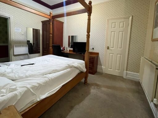 A dilapidated hotel bedroom with stained carpets and peeling wallpaper in Preston is on sale for £40,000, leaving bewildered Brits questioning what exactly they would be buying.