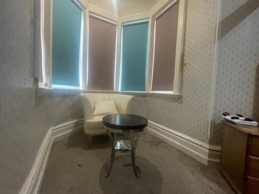 A dilapidated hotel bedroom with stained carpets and peeling wallpaper in Preston is on sale for £40,000, leaving bewildered Brits questioning what exactly they would be buying.