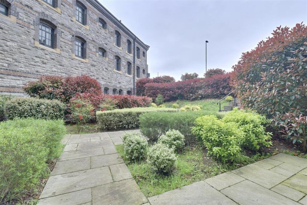 A luxury flat inside one of Britain's most notorious former prisons is on the market for £180,000 - the Victorian jail once housed serial killer Archibald Hall and EastEnders star Leslie Grantham.