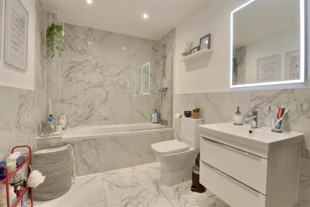 A luxury flat inside one of Britain's most notorious former prisons is on the market for £180,000 - the Victorian jail once housed serial killer Archibald Hall and EastEnders star Leslie Grantham.
