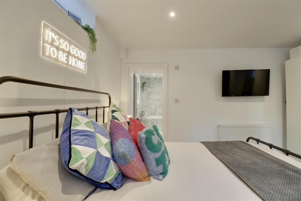 A luxury flat inside one of Britain's most notorious former prisons is on the market for £180,000 - the Victorian jail once housed serial killer Archibald Hall and EastEnders star Leslie Grantham.