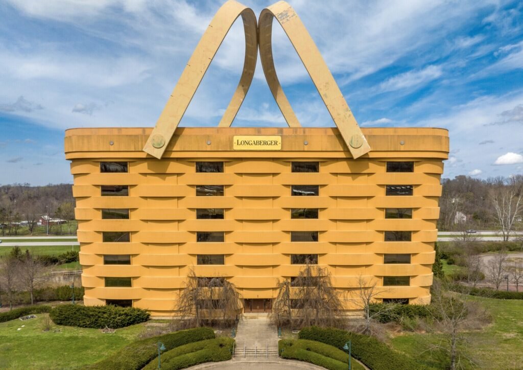A seven-storey office building shaped like a giant picnic basket is back on the market for $8.5m - complete with 75-ton handles fitted with heating elements to stop ice building up.