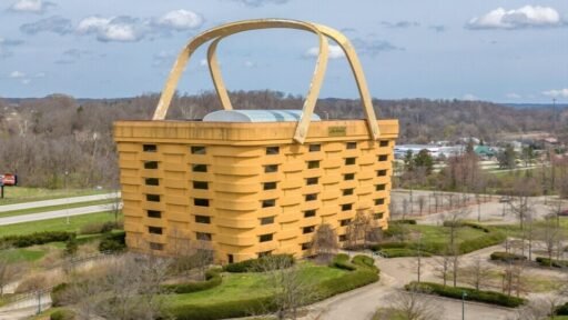 A seven-storey office building shaped like a giant picnic basket is back on the market for $8.5m - complete with 75-ton handles fitted with heating elements to stop ice building up.