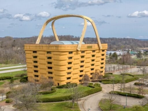 A seven-storey office building shaped like a giant picnic basket is back on the market for $8.5m - complete with 75-ton handles fitted with heating elements to stop ice building up.