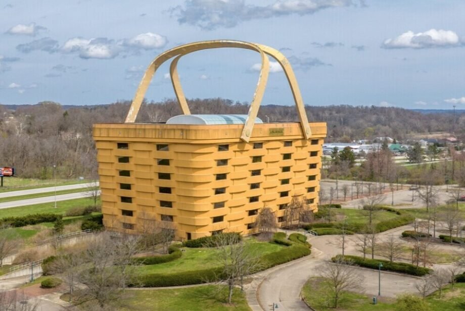 A seven-storey office building shaped like a giant picnic basket is back on the market for $8.5m - complete with 75-ton handles fitted with heating elements to stop ice building up.