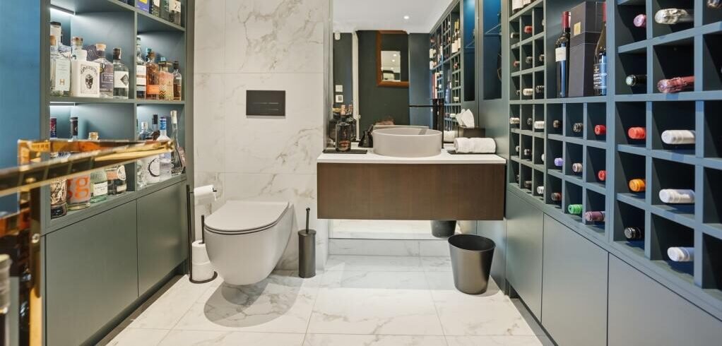 A Victorian flat on the market for £500,000 in Scotland comes with a rather unusual feature - a downstairs loo that appears to double as a fully stocked wine cellar.