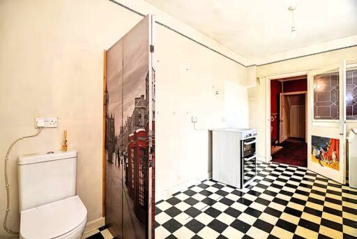 A three-bed home has gone on sale for £110,000 with an "un-loo-sual" twist - a toilet hidden in the kitchen, just feet from the cooker, fridge and sink.