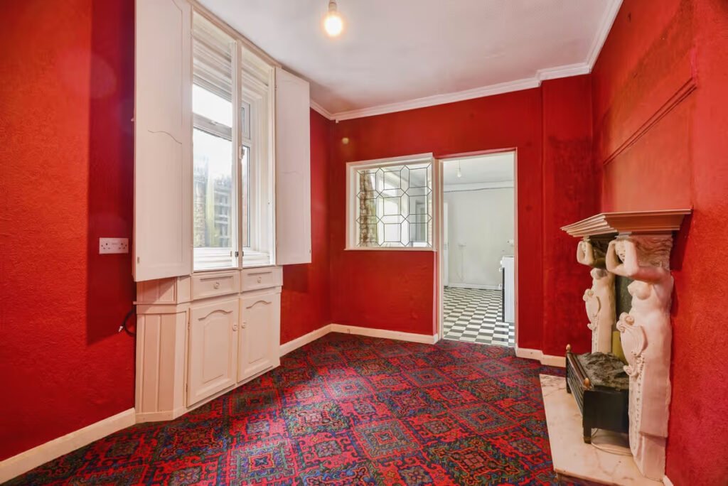 A three-bed home has gone on sale for £110,000 with an "un-loo-sual" twist - a toilet hidden in the kitchen, just feet from the cooker, fridge and sink.