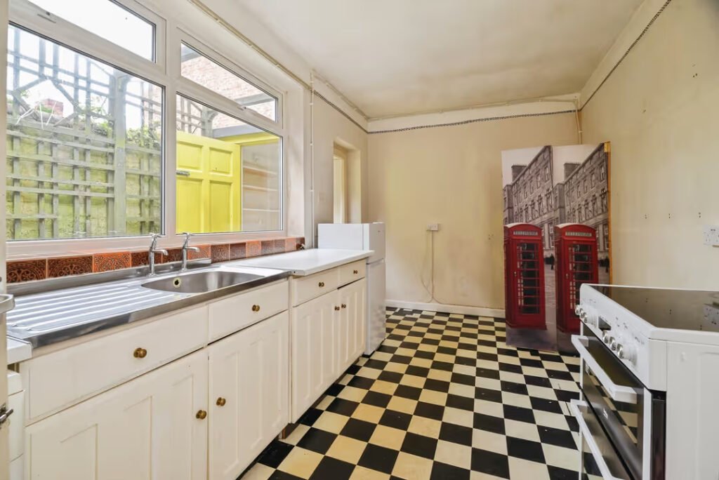 A three-bed home has gone on sale for £110,000 with an "un-loo-sual" twist - a toilet hidden in the kitchen, just feet from the cooker, fridge and sink.