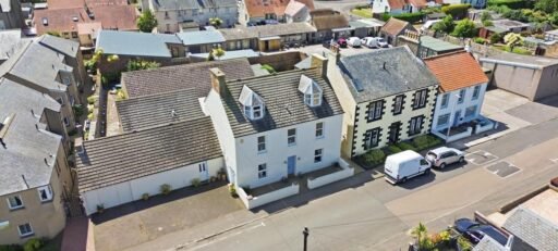 An ordinary-looking house on sale for £600,000 hides a huge ballroom with a dance floor, stage and starry ceiling - plus a stone wishing well in the dining room.
