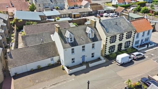 An ordinary-looking house on sale for £600,000 hides a huge ballroom with a dance floor, stage and starry ceiling - plus a stone wishing well in the dining room.