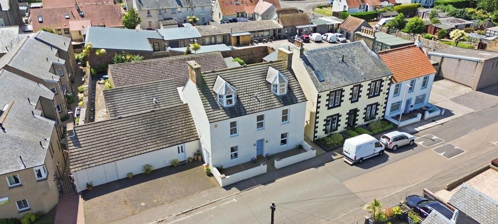 An ordinary-looking house on sale for £600,000 hides a huge ballroom with a dance floor, stage and starry ceiling - plus a stone wishing well in the dining room.