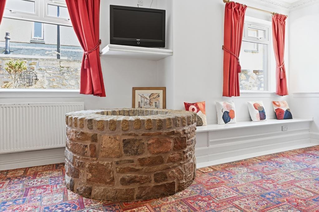 An ordinary-looking house on sale for £600,000 hides a huge ballroom with a dance floor, stage and starry ceiling - plus a stone wishing well in the dining room.