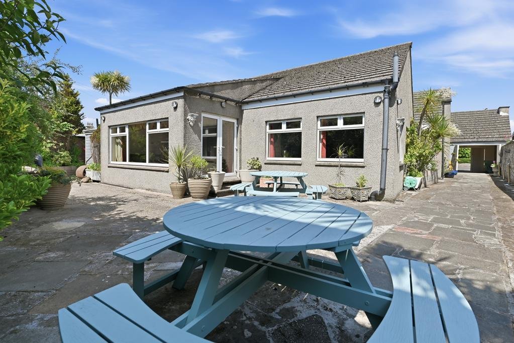 An ordinary-looking house on sale for £600,000 hides a huge ballroom with a dance floor, stage and starry ceiling - plus a stone wishing well in the dining room.
