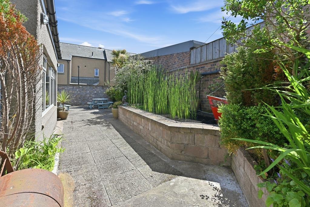 An ordinary-looking house on sale for £600,000 hides a huge ballroom with a dance floor, stage and starry ceiling - plus a stone wishing well in the dining room.