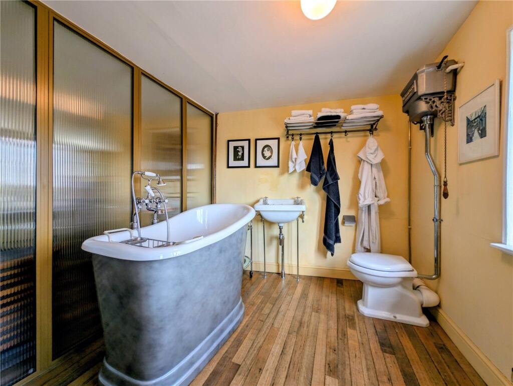A quaint £220,000 cottage has gone on the market - but its bathroom arrangement, with the loo and bath behind see-through glass, may leave buyers feeling flushed.