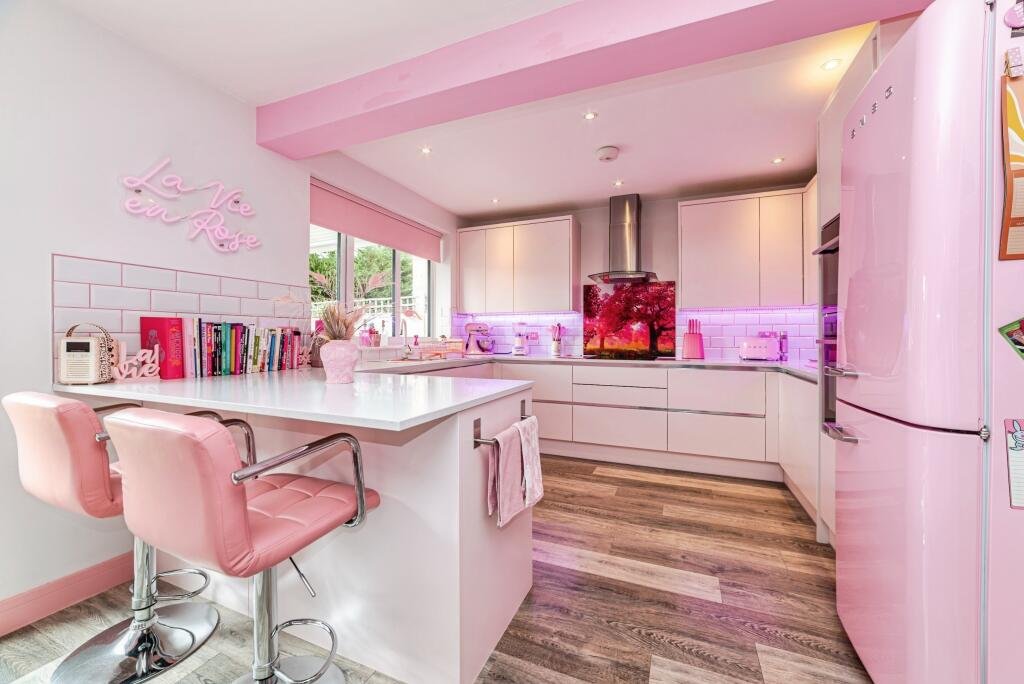 Britain's own Barbie Dream House is on sale for £725,000 - with a bubblegum kitchen, pink staircase, pink SMEG fridge and even a pink garage door.