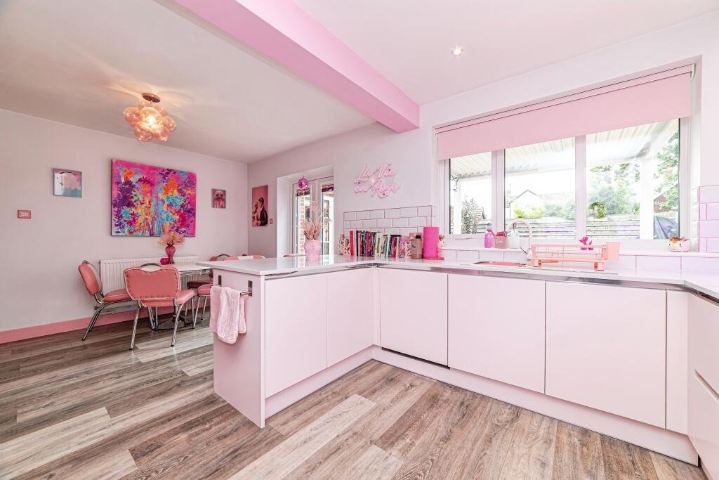 Britain's own Barbie Dream House is on sale for £725,000 - with a bubblegum kitchen, pink staircase, pink SMEG fridge and even a pink garage door.