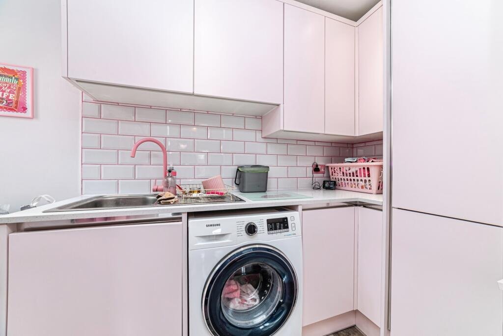Britain's own Barbie Dream House is on sale for £725,000 - with a bubblegum kitchen, pink staircase, pink SMEG fridge and even a pink garage door.