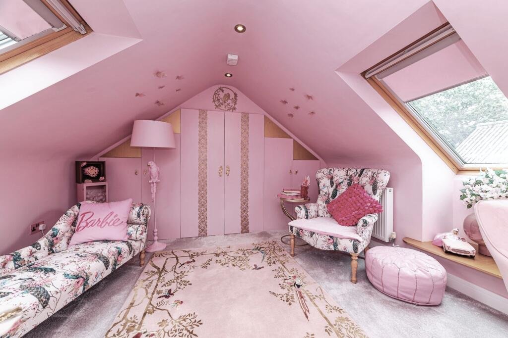 Britain's own Barbie Dream House is on sale for £725,000 - with a bubblegum kitchen, pink staircase, pink SMEG fridge and even a pink garage door.