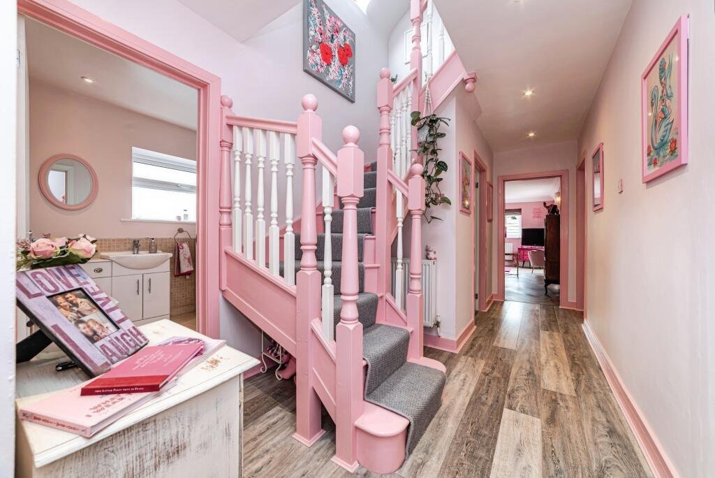Britain's own Barbie Dream House is on sale for £725,000 - with a bubblegum kitchen, pink staircase, pink SMEG fridge and even a pink garage door.
