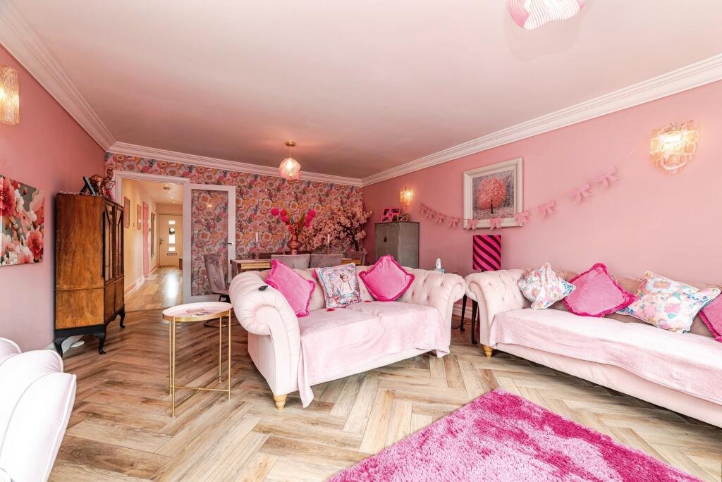 Britain's own Barbie Dream House is on sale for £725,000 - with a bubblegum kitchen, pink staircase, pink SMEG fridge and even a pink garage door.