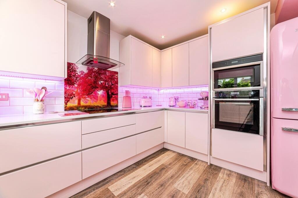 Britain's own Barbie Dream House is on sale for £725,000 - with a bubblegum kitchen, pink staircase, pink SMEG fridge and even a pink garage door.
